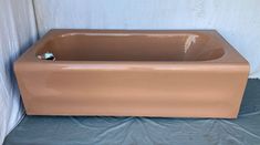 a tan bath tub sitting on top of a blue sheet