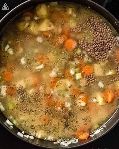 a pot filled with soup sitting on top of a stove