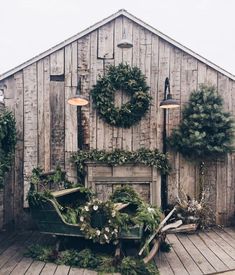 the instagram page shows an image of a wooden building with wreaths on it