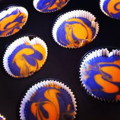 cupcakes with orange and blue frosting on them