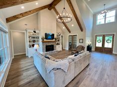 a large living room with wood floors and white walls