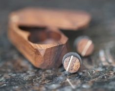 two wooden objects sitting on the ground next to each other