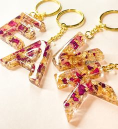 three pieces of glass sitting on top of each other with gold chains attached to them