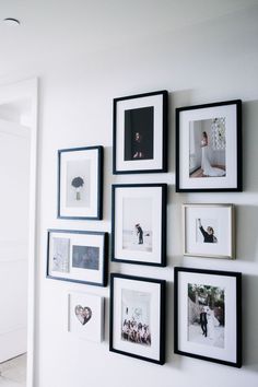 several black and white pictures hanging on the wall