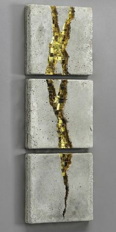 three pieces of cement with gold paint on them