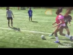 three girls are playing soccer on the field