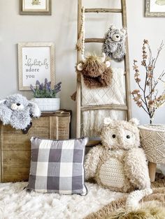 a teddy bear sitting on top of a bed next to two stuffed animals and a ladder