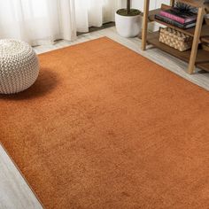 an orange area rug in a living room