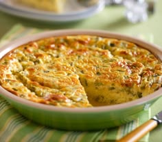 a green dish filled with food on top of a table