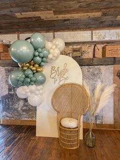 a chair and balloons are on display in a room