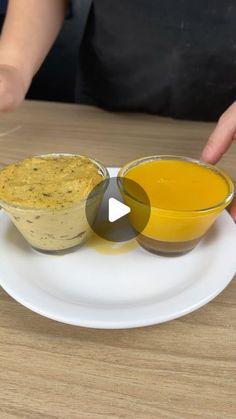 two bowls of food on a plate with one being dipping the other into another bowl