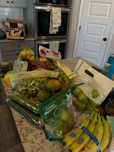 some bananas and other fruits on a kitchen counter