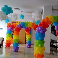 an arch made out of balloons in the middle of a room