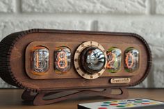 a wooden clock with four different clocks on it