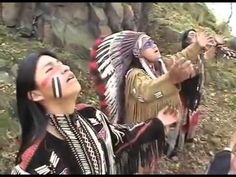 two native american people standing next to each other