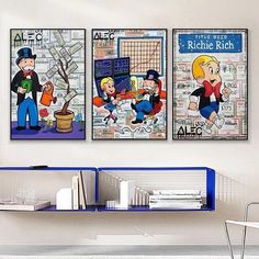 two cartoon posters are hanging on the wall above a blue shelf in a white room