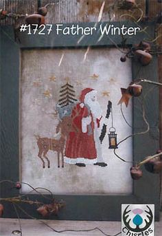 a cross stitch picture with santa and deer