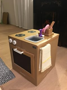 an oven made out of cardboard sitting on the floor