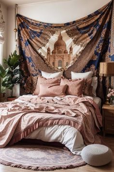 a bedroom with a large tapestry hanging over the bed and pillows on the floor next to it