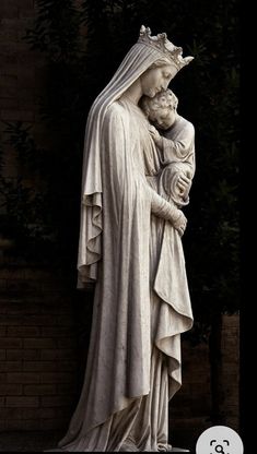 a statue of jesus holding a child in his arms