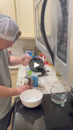 a man in a kitchen preparing food on the stove