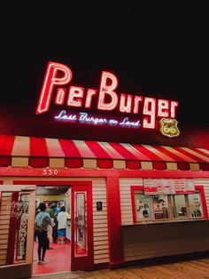 the entrance to a burger restaurant at night