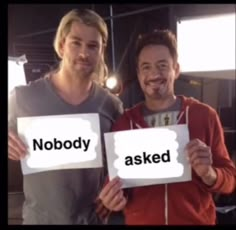 two men holding up signs that say nobody and asked