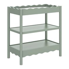 a green shelf with scalloped edges on the top and bottom, against a white background