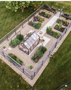 an aerial view of a vegetable garden in the middle of a yard with gravel and rocks