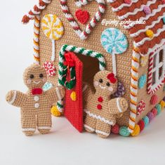 a crocheted gingerbread house is decorated with candy canes