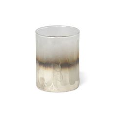 a white and brown glass vase sitting on top of a table