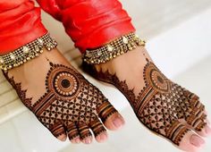 a woman's feet with hennap and bracelets