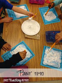 children are painting with watercolors on the table