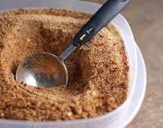 a spoon in a bowl filled with sand