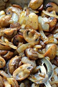 mushrooms and onions in a bowl with a spoon