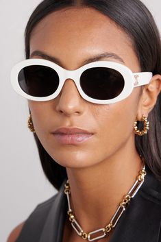 CELINE Eyewear's sunglasses have been made in Italy from white acetate and have modern oval-shaped frames. They're adorned with an archival logo plaque - first introduced by the label's founder in 1973 - and fitted with dark lenses. Celine Eyewear, Celine Triomphe, White Sunglasses, Gucci Eyewear, Acetate Sunglasses, Trending Sunglasses, Cool Sunglasses, Oval Sunglasses, Eyewear Womens