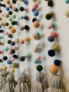 multi colored balls and tassels hanging on a wall