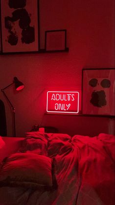 there is a neon sign that says adults only on the wall next to a bed