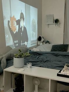 a bed room with a large screen on the wall