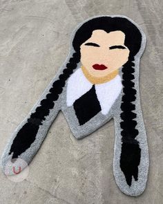 an image of a woman's face on the ground with her hair pulled back