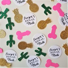 some pineapples and other items are on a white board with pink, green and gold glitter