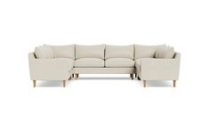 a white sectional couch with wooden legs and arm rests on an off - white background