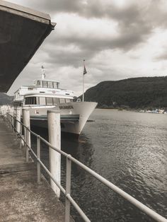 a large white boat is docked at the dock