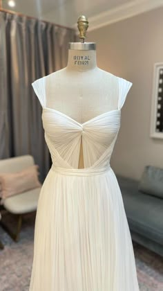 a white dress on display in a room