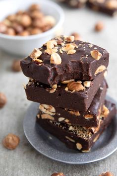 three pieces of chocolate fudge with nuts on top