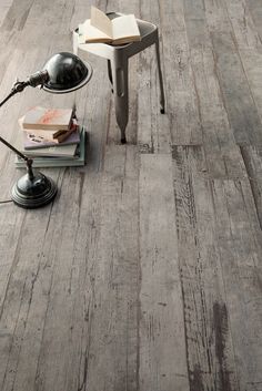 a table with a lamp and books on it