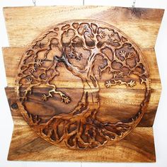 a wooden plaque with an image of a tree in the shape of a circle on it