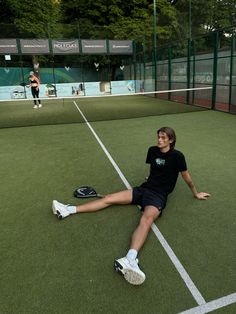 a woman laying on the tennis court with her legs spread out