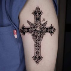 a cross tattoo on the right arm