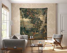 a living room filled with furniture and a large tapestry hanging on the wall above it